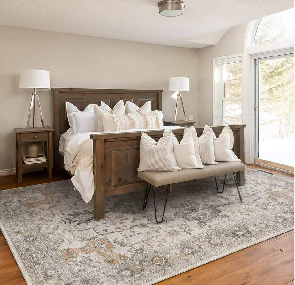 Bedroom with wooden bed, bench, and lamps in a well-lit room.