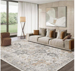 Modern living room with a beige sofa, patterned rug, and abstract painting.
