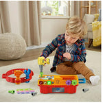 Child playing with tool set on floor