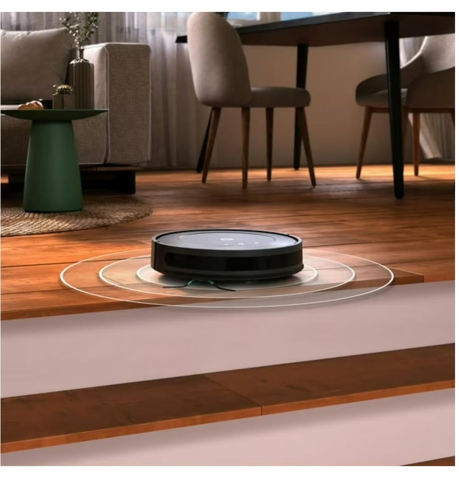 Robotic vacuum cleaner on a wooden floor with a living room
