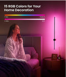 Woman sitting on a bed with a wall-mounted RGB light fixture casting a pink glow.
