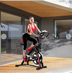 Woman exercising on a stationary bike in a modern indoor setting
