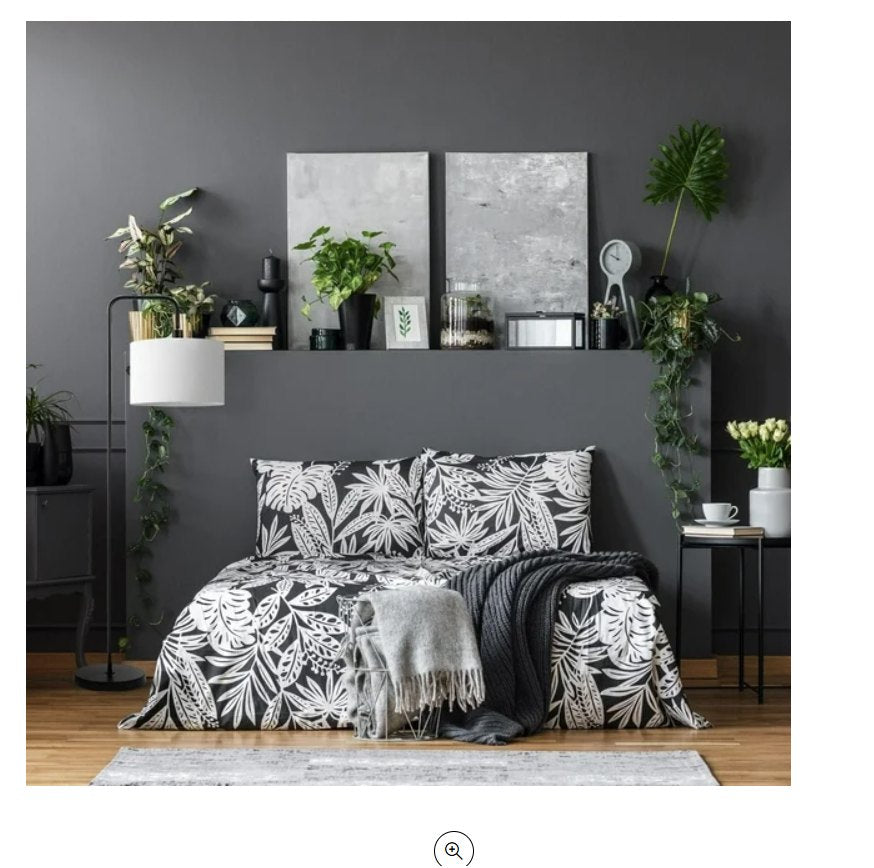 Bedroom with black and white floral bedding.