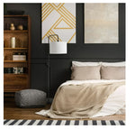 A bed with beige bedding and decorative elements.