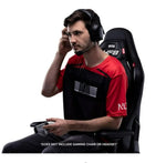 Man sitting in a gaming chair with a headset on