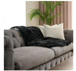Grey sofa and warm soft fabric black blanket 
