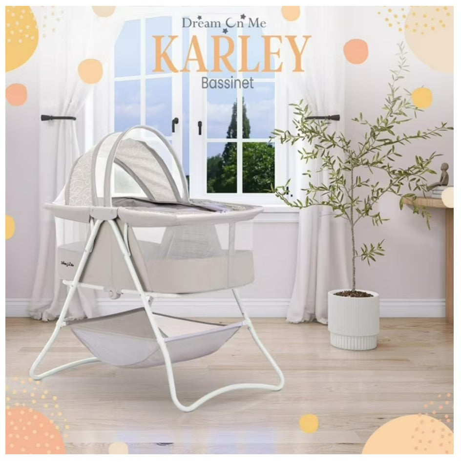 Dream On Me Karley bassinet in a room with a window and plant