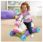 Child riding a colorful toy unicorn in a room with toys and furniture.