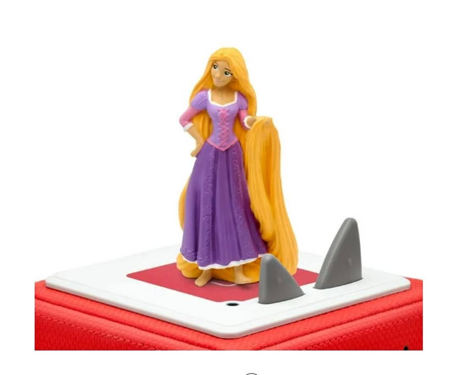 Toy figure of a princess with long blonde hair on a red and white base.