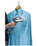 Person ironing a blue shirt on a hanger with a steam iron.