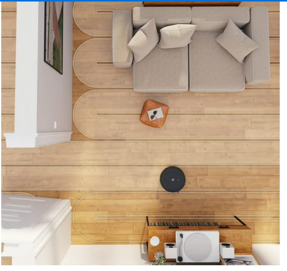 Top-down view of a living room with a sofa, coffee table, and decorative items.