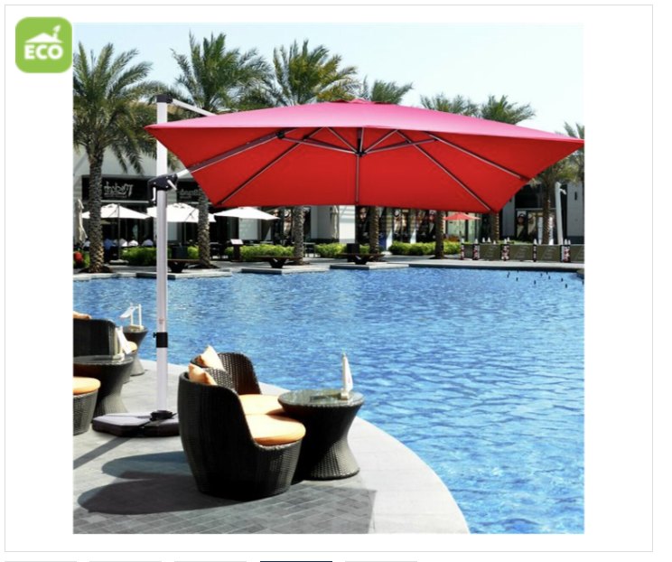 Red patio umbrella over a poolside area with chairs and palm trees