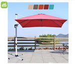 Red patio umbrella with a stand on a patio