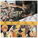 Kid playing and looking at a book and anime print