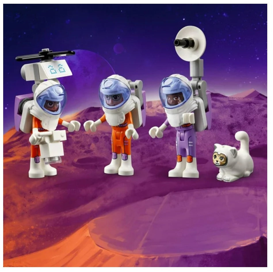 Toy figures of astronauts and a cat on a space-themed