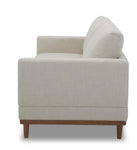 Beige armchair with wooden legs.