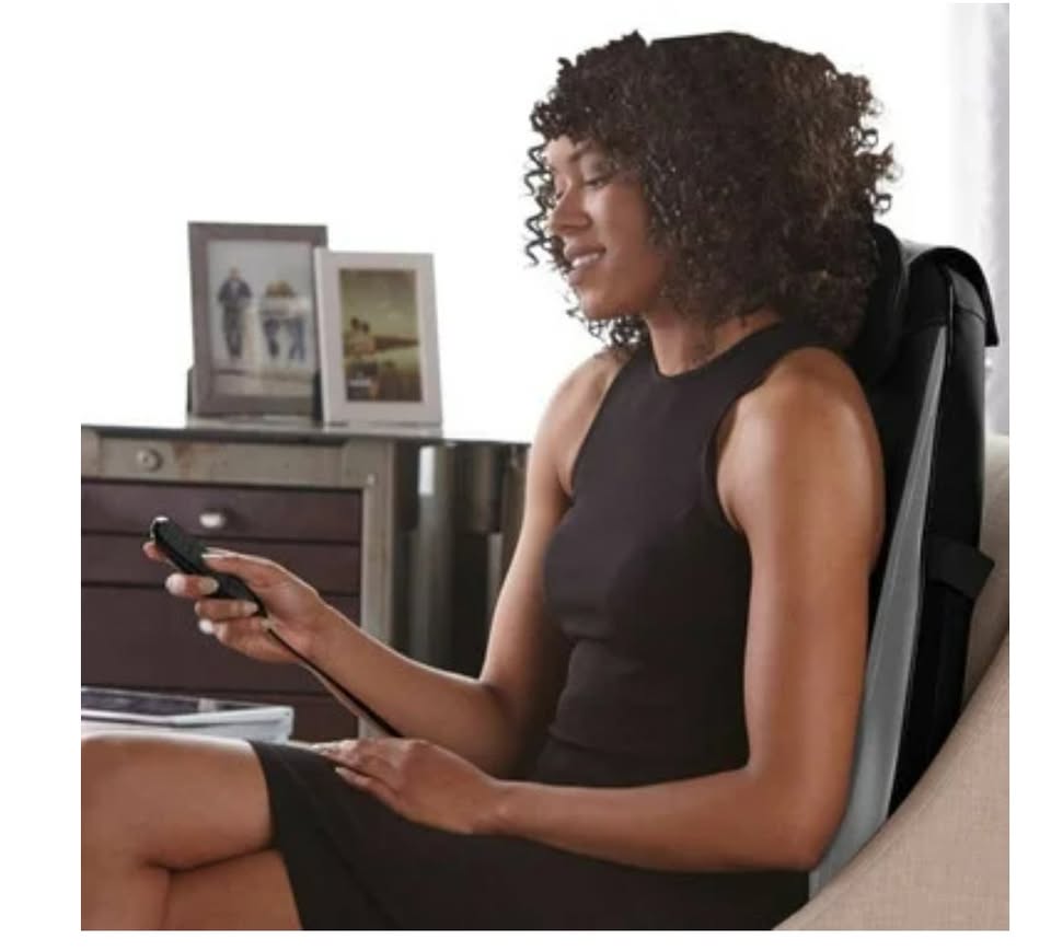 Woman using a massage chair in a home setting